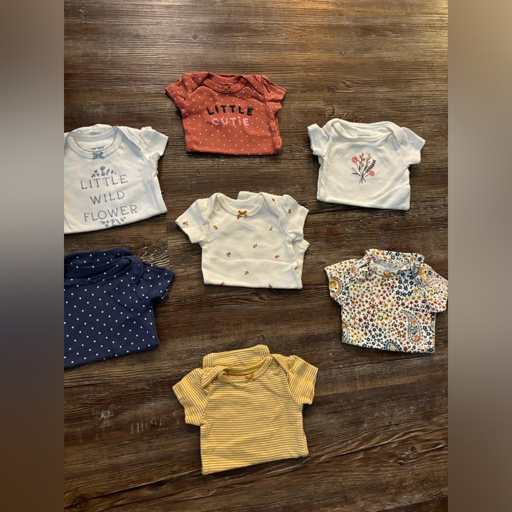 7 pack of Carter’s newborn short sleeve onesies